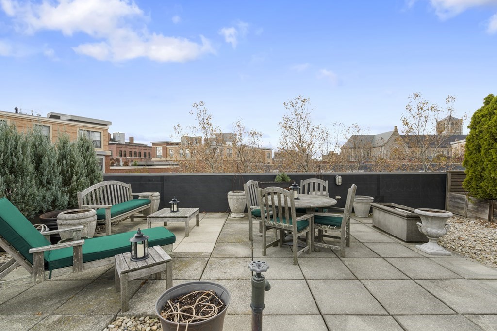 15 Savoy Street, Unit D309 Boston, MA 02118 - Photo 27 of 31 a view of a terrace with furniture and a fire pit