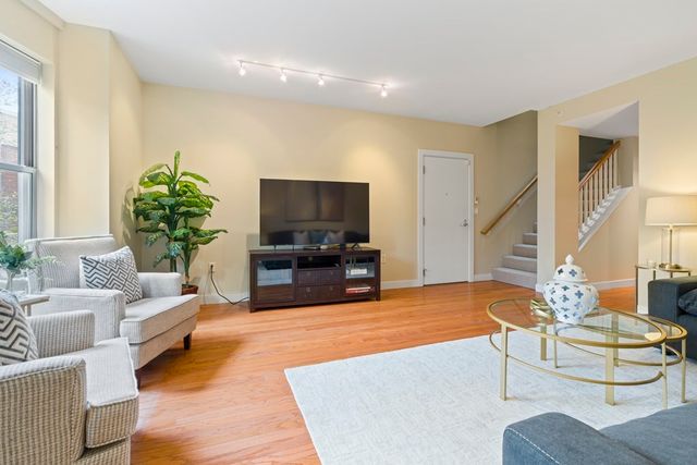 a living room with fireplace furniture and a flat screen tv