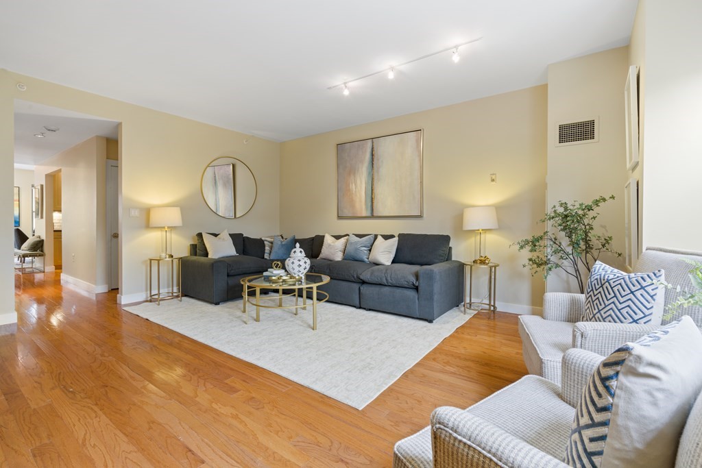 15 Savoy Street, Unit D309 Boston, MA 02118 - Photo 4 of 31 a living room with furniture and wooden floor
