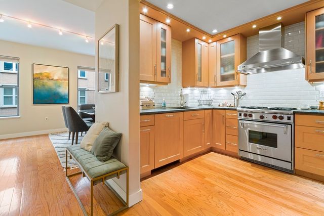 a kitchen with a stove a sink and a refrigerator