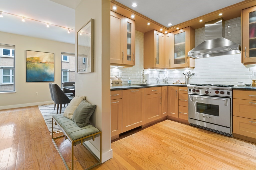 15 Savoy Street, Unit D309 Boston, MA 02118 - Photo 5 of 31 a kitchen with a stove a sink and a refrigerator