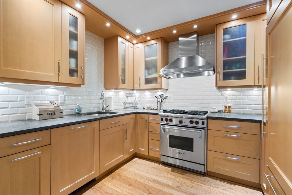 15 Savoy Street, Unit D309 Boston, MA 02118 - Photo 7 of 31 a kitchen with a stove and white cabinets