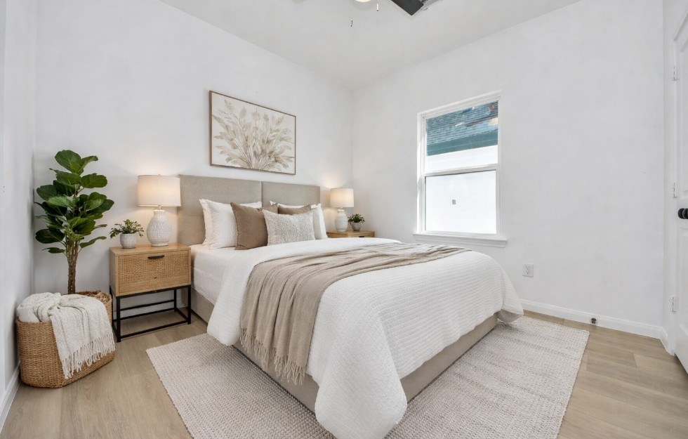 8653 Sunderland Road Houston, TX 77028 - Photo 11 of 14 a bedroom with a bed and a potted plant