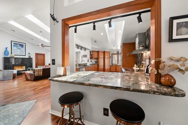 a kitchen with granite countertop a stove and cabinets