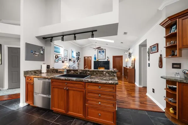 a kitchen with stainless steel appliances granite countertop a refrigerator and a sink