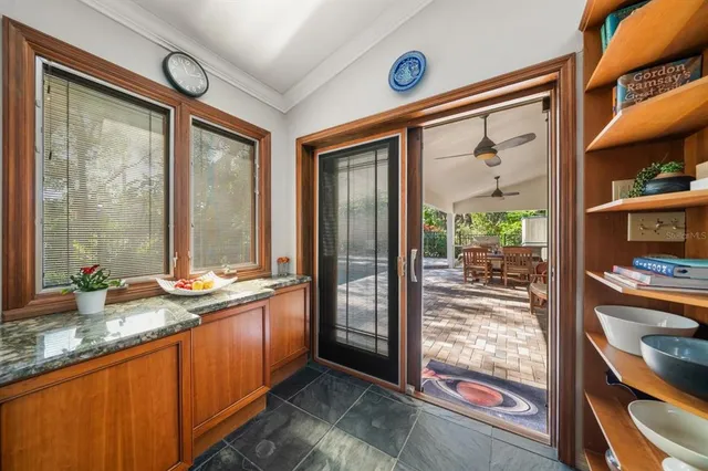 a living room with furniture a ceiling fan and a fireplace