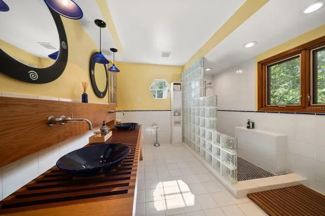 a spacious bedroom with a bed and wooden floor