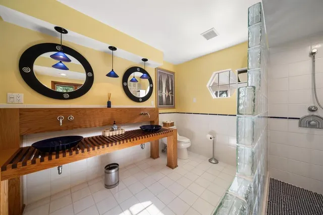 a bathroom with double vanity sinks and a mirror