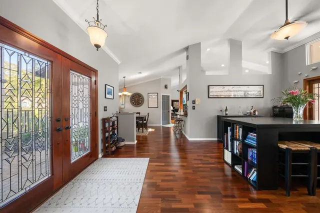a view of a livingroom kitchen and dinning room with wooden floor