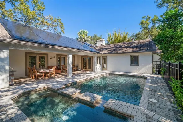 a backyard of a house with barbeque oven table and chairs