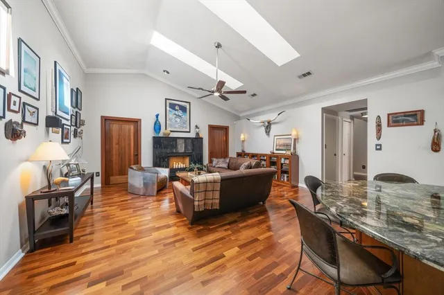 a living room with fireplace furniture and a wooden floor