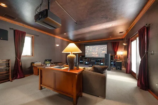 a living room with furniture a window and a flat screen tv
