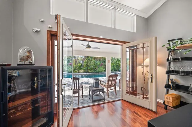 a living room with furniture a rug and a floor to ceiling window