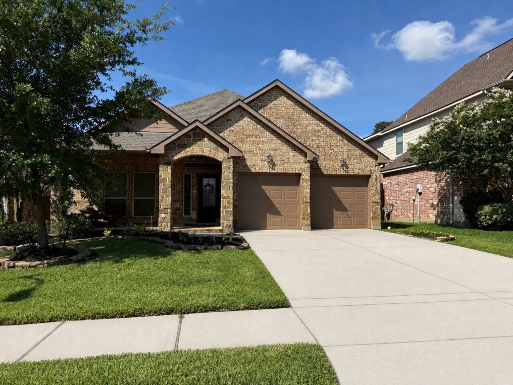 23911 Augusta Falls Lane Spring, TX 77389 - Photo 1 of 1 a front view of a house with a garden and yard
