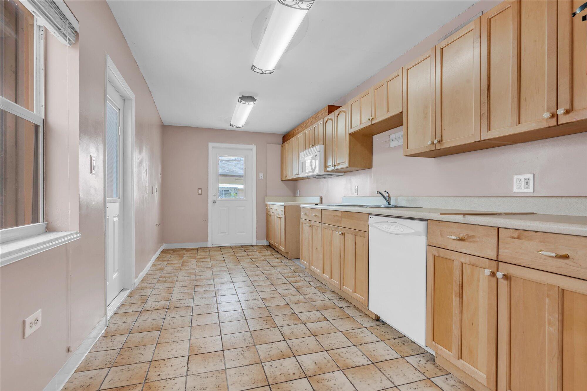 7984 Tuna Drive Marathon, FL 33050 - Photo 12 of 40 a kitchen with stainless steel appliances granite countertop a refrigerator and a sink