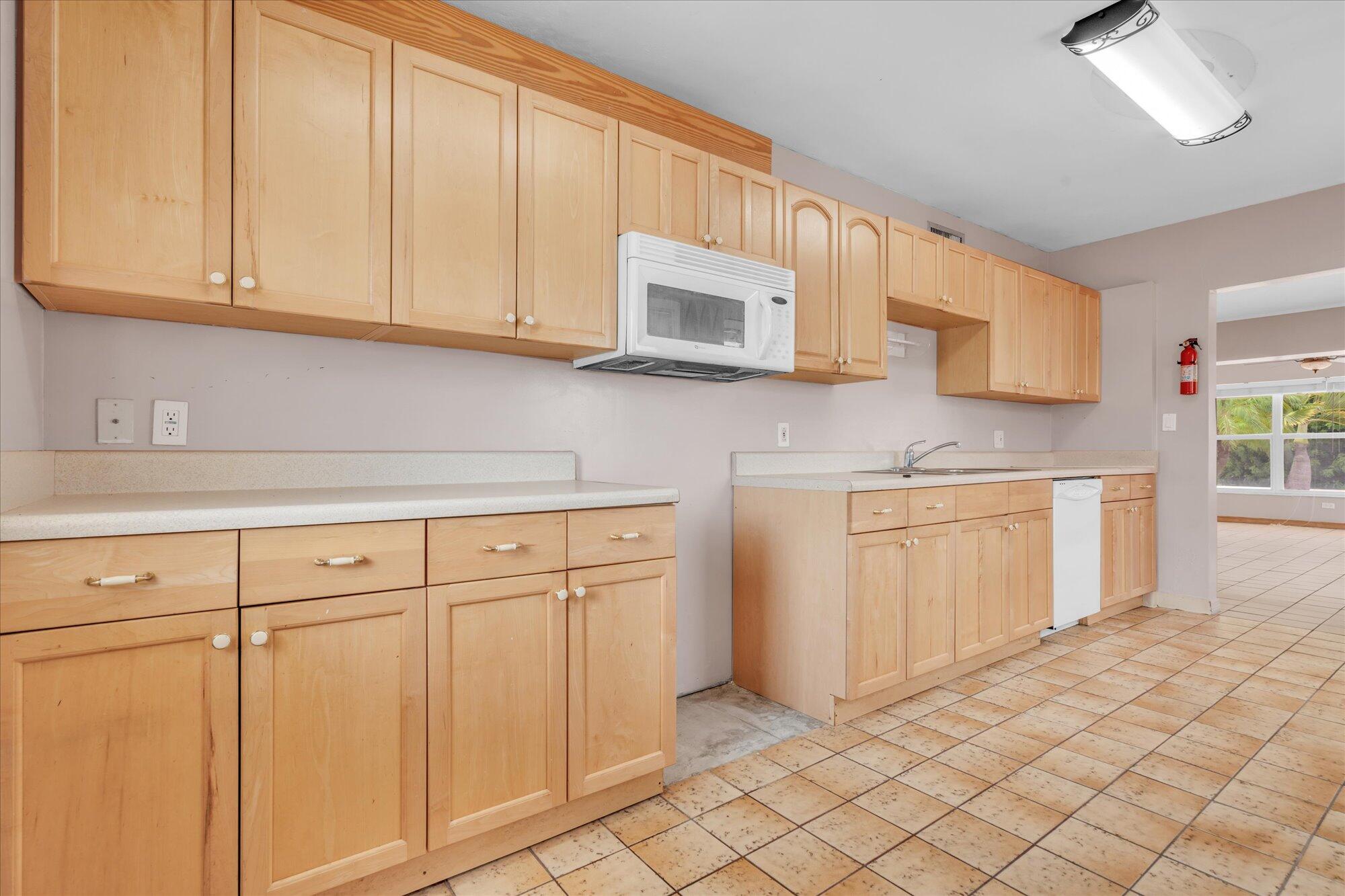 7984 Tuna Drive Marathon, FL 33050 - Photo 13 of 40 a kitchen with white cabinets