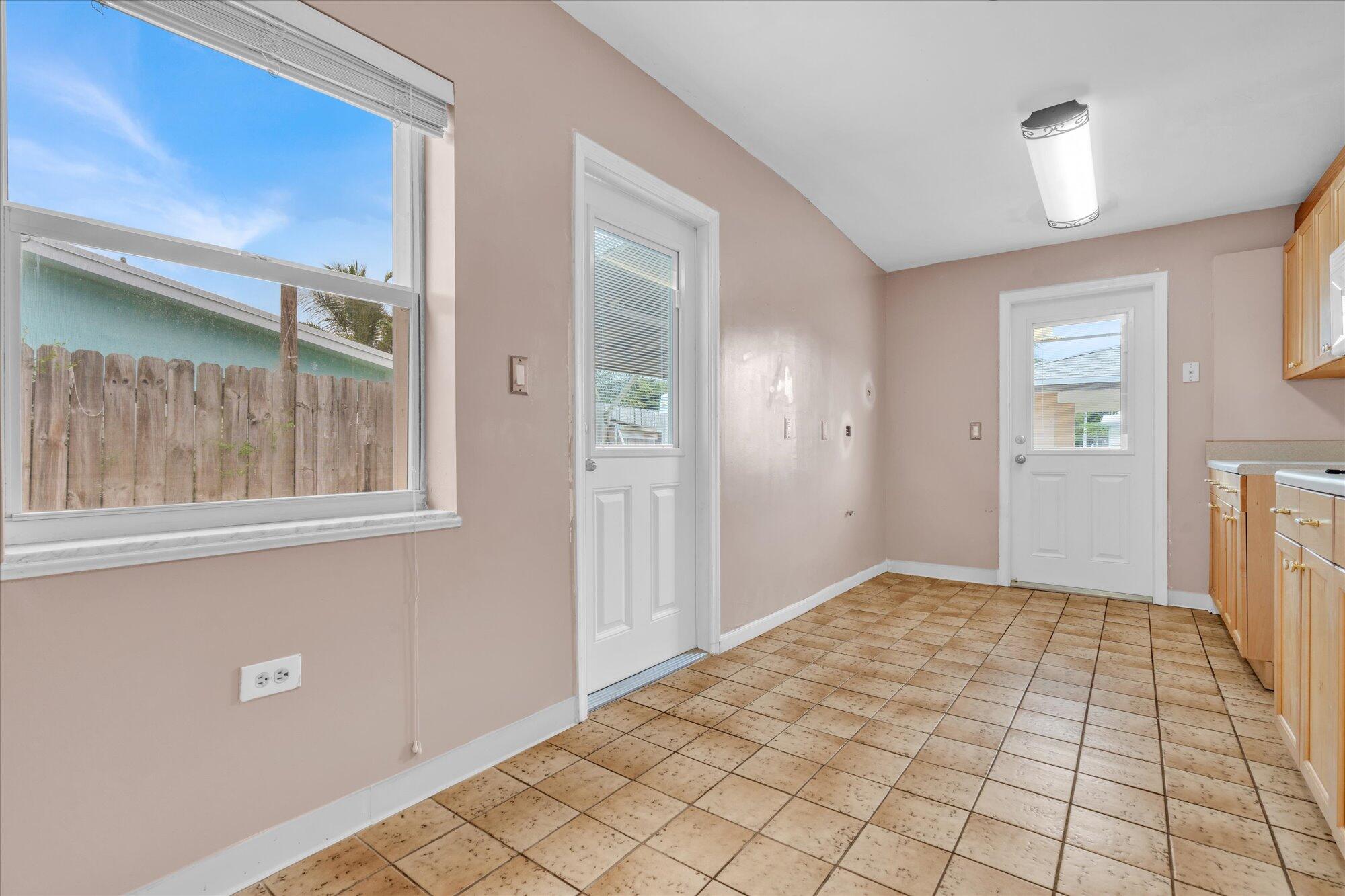 7984 Tuna Drive Marathon, FL 33050 - Photo 14 of 40 a view of an empty room with window and chandelier