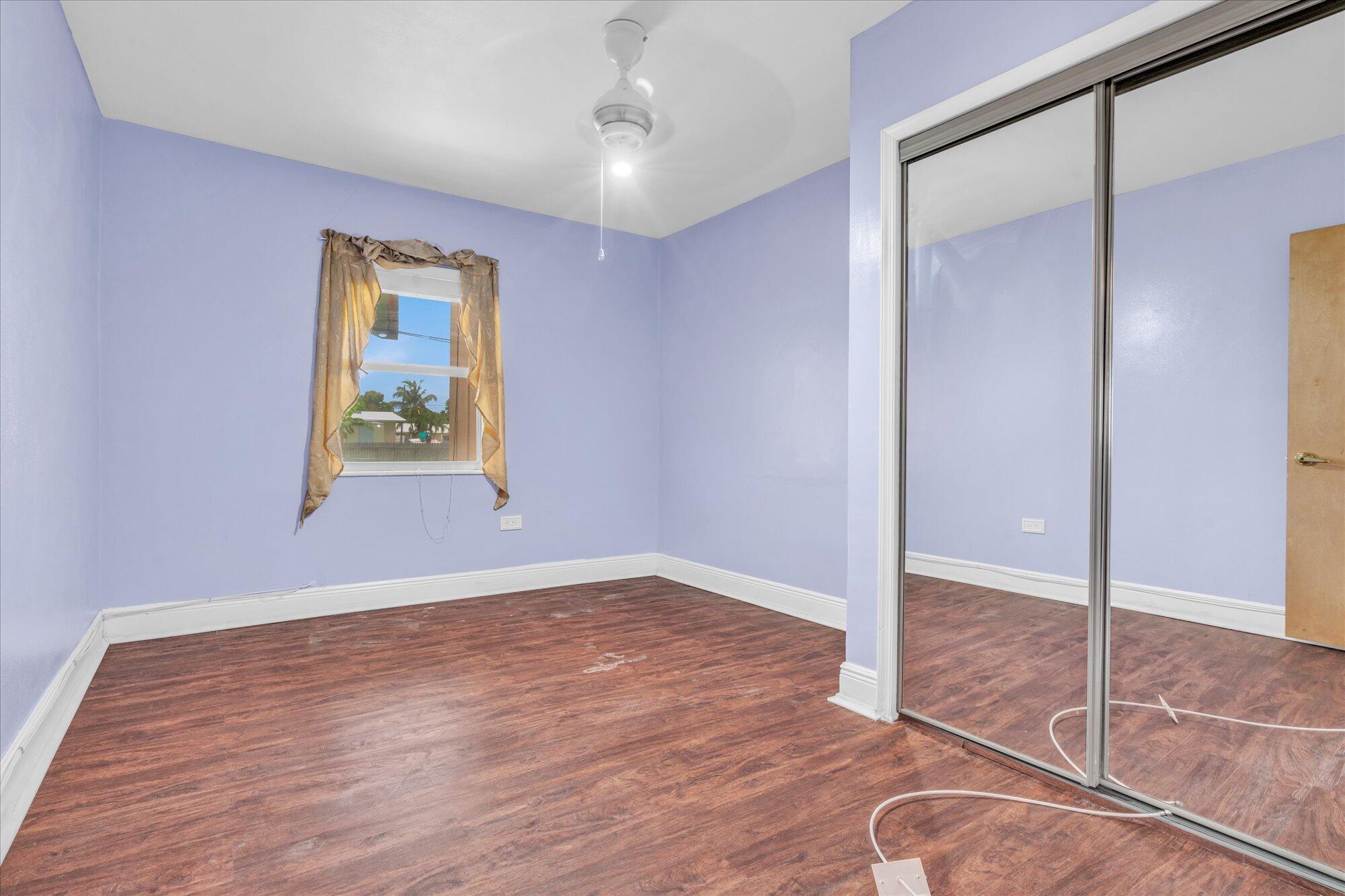 7984 Tuna Drive Marathon, FL 33050 - Photo 18 of 40 an empty room with wooden floor and windows