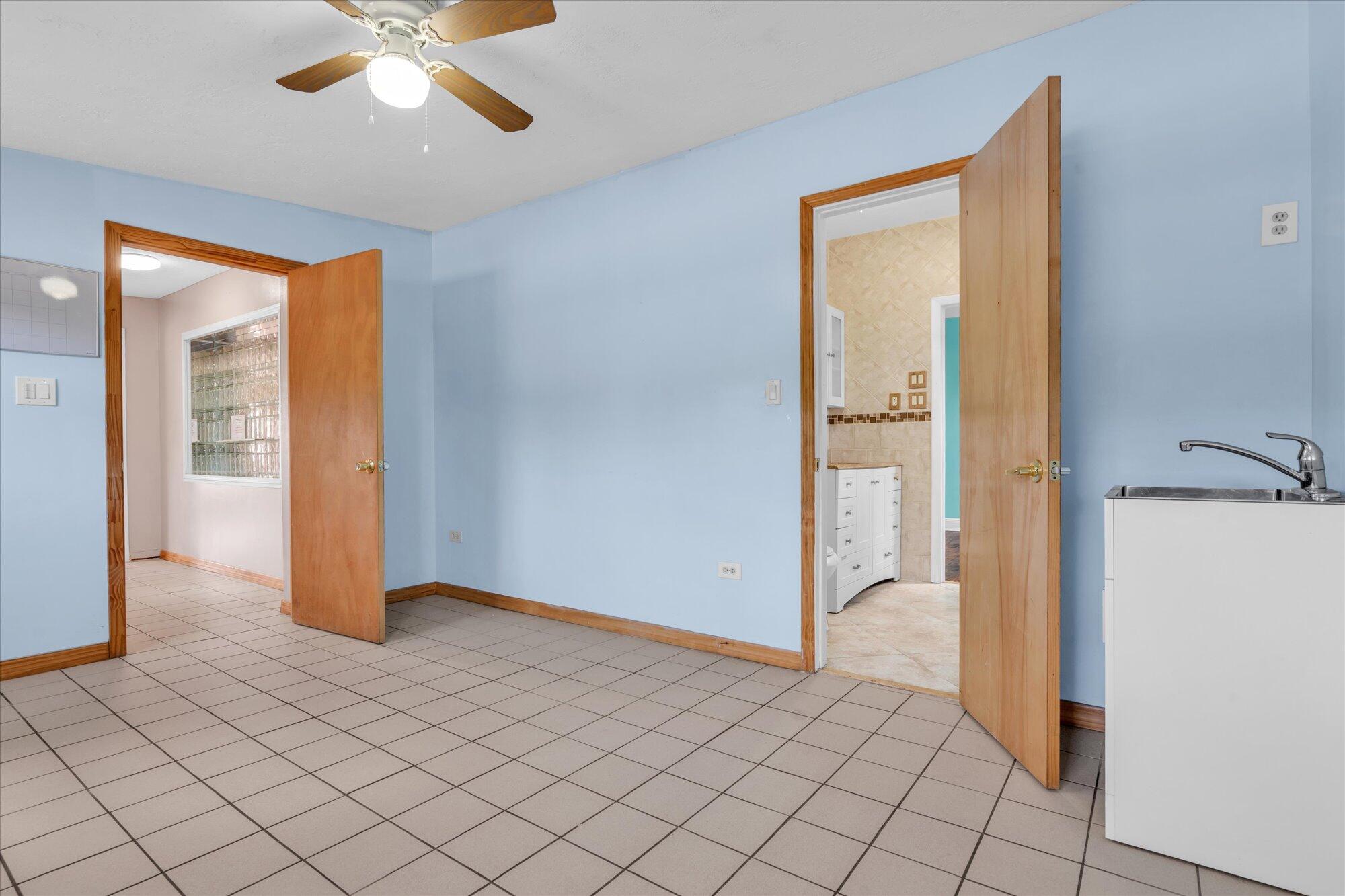 7984 Tuna Drive Marathon, FL 33050 - Photo 26 of 40 an empty room and chandelier fan wooden floor and windows
