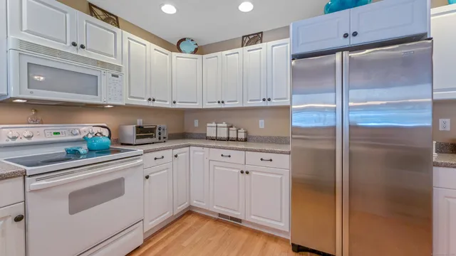 a kitchen with appliances a sink and cabinets