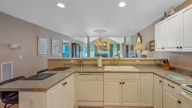 a view of a dining room with furniture and chandelier