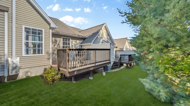 a view of a house with a yard and deck