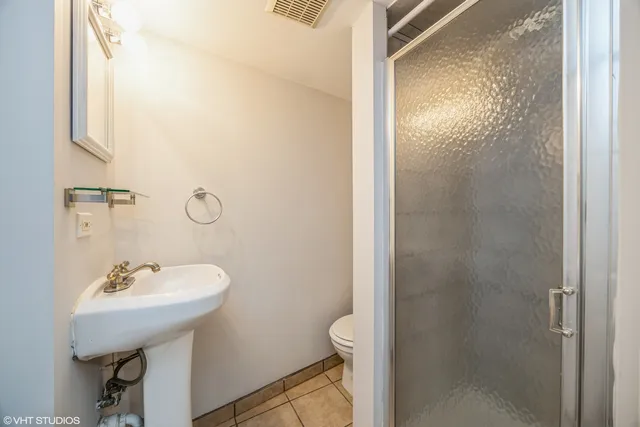 a bathroom with a sink toilet and a mirror