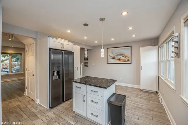 a hallway with cabinets and wooden floor
