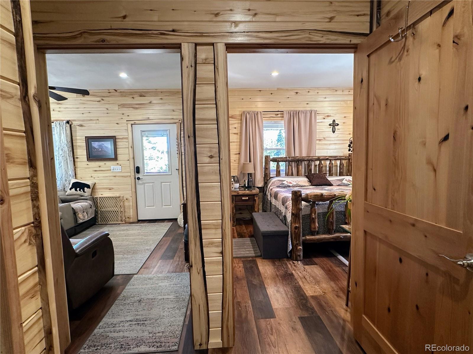 2945 Forbes Park Road Fort Garland, CO 81133 - Photo 11 of 36 a view of a bedroom with a bed and wooden floor