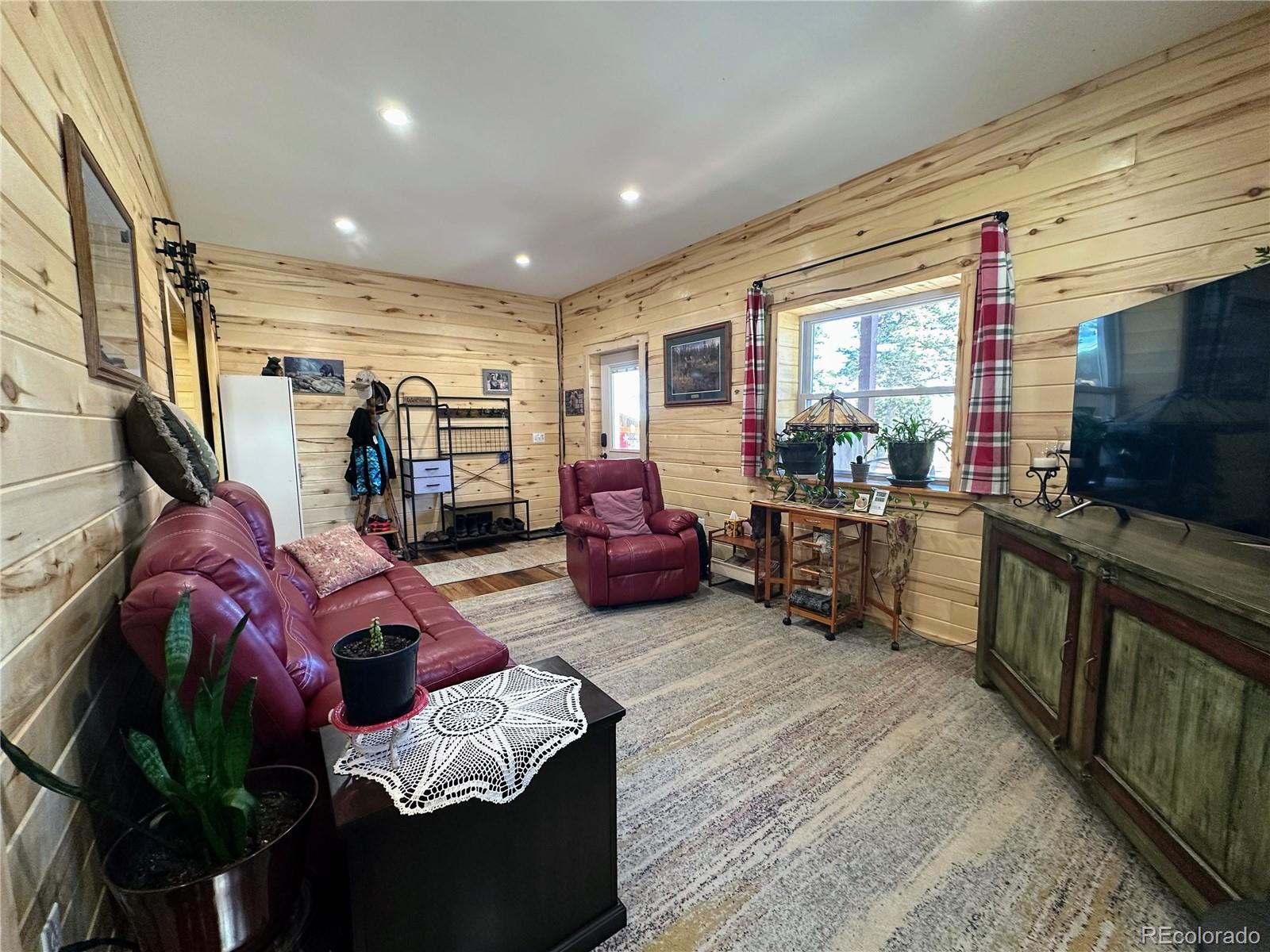 2945 Forbes Park Road Fort Garland, CO 81133 - Photo 18 of 36 a living room with furniture fireplace and flat screen tv