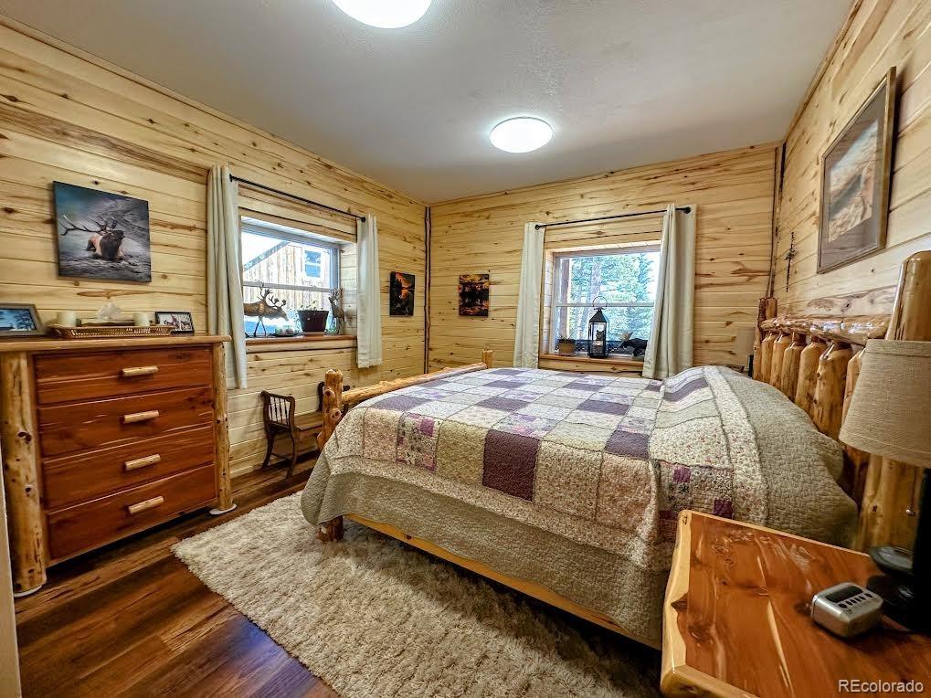 2945 Forbes Park Road Fort Garland, CO 81133 - Photo 19 of 36 a bedroom with a bed and wooden floor
