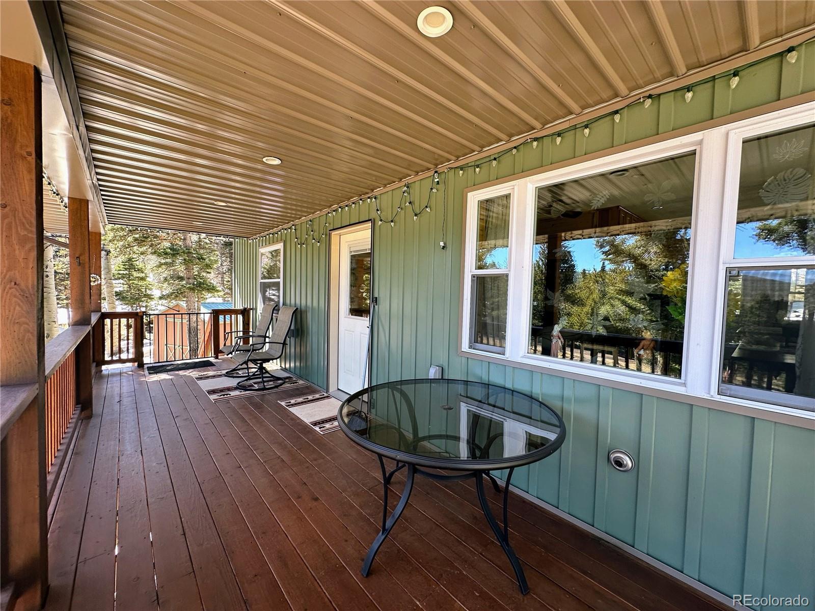 2945 Forbes Park Road Fort Garland, CO 81133 - Photo 6 of 36 a view of a deck with wooden floor and furniture