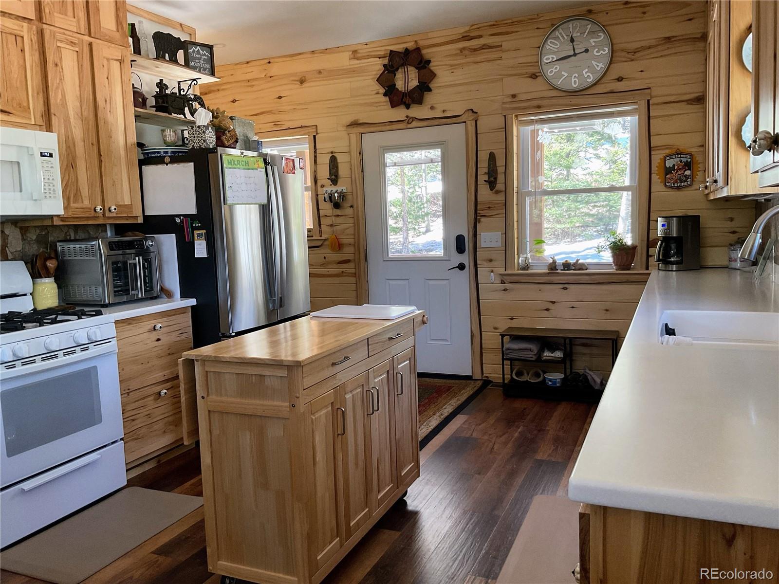2945 Forbes Park Road Fort Garland, CO 81133 - Photo 10 of 36 a kitchen with stainless steel appliances granite countertop a stove a sink and a refrigerator