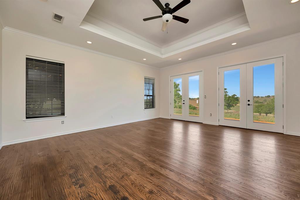 5520 White Settlement Road Weatherford, TX 76087 - Photo 12 of 40 a view of an empty room with window and wooden floor