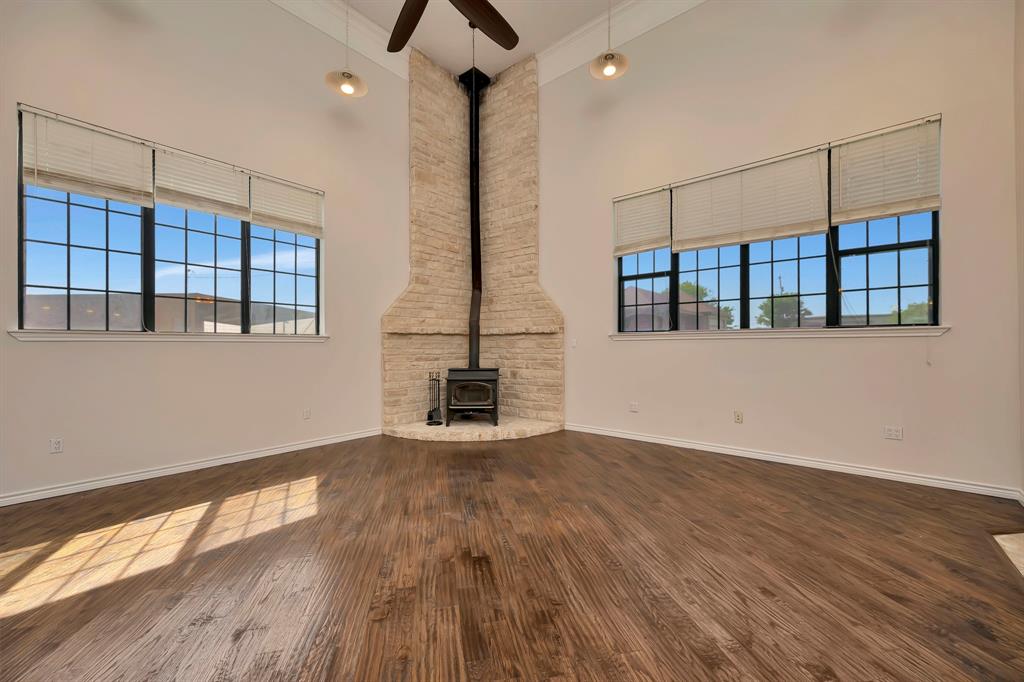5520 White Settlement Road Weatherford, TX 76087 - Photo 23 of 40 a view of an empty room with wooden floor and a window