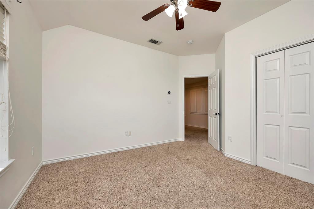 5520 White Settlement Road Weatherford, TX 76087 - Photo 39 of 40 an empty room with chandelier fan