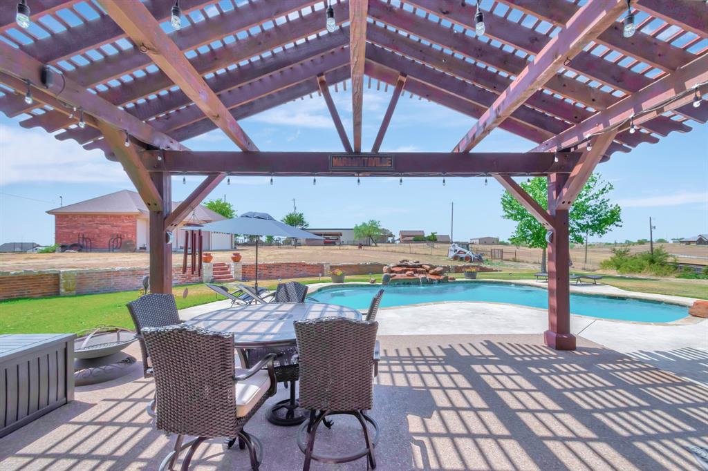 5520 White Settlement Road Weatherford, TX 76087 - Photo 4 of 40 a view of a patio with a table chairs and a backyard