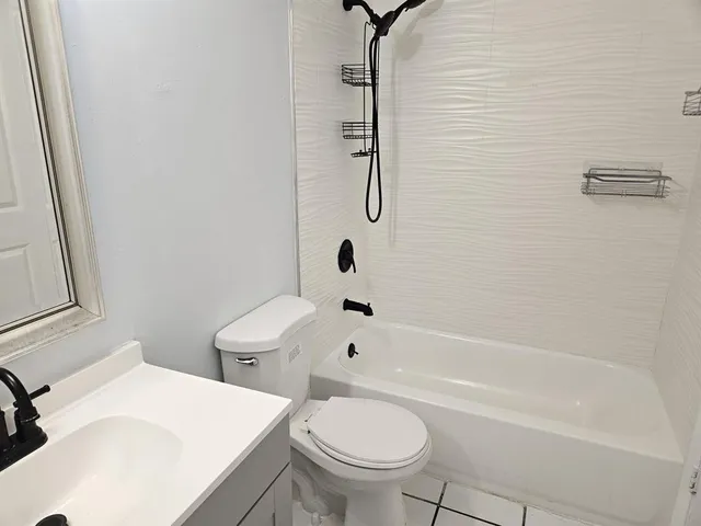 a bathroom with a sink a toilet and a bathtub