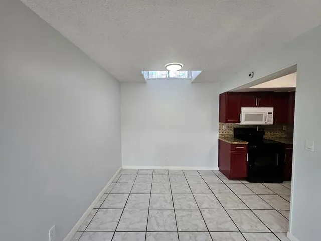 a view of an empty room with a mirror