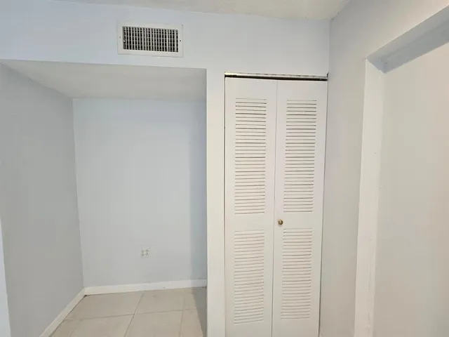 a view of a bedroom with a white walls