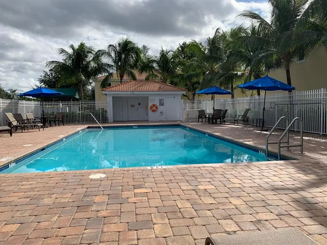 a view of house with outdoor space and swimming pool