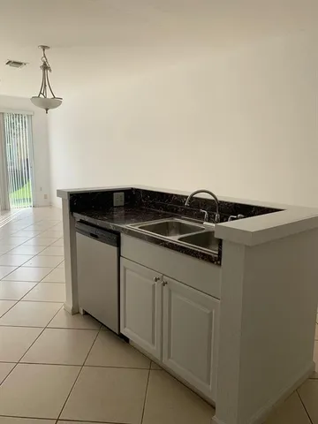 a close view of a stove a sink and dishwasher