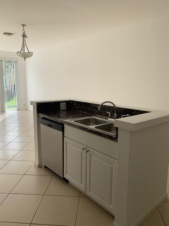 6366 Landings Way, Unit 6366 Tamarac, FL 33321 - Photo 5 of 19 a close view of a stove a sink and dishwasher