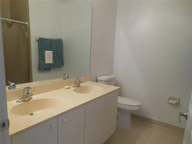 a bathroom with a sink toilet and mirror