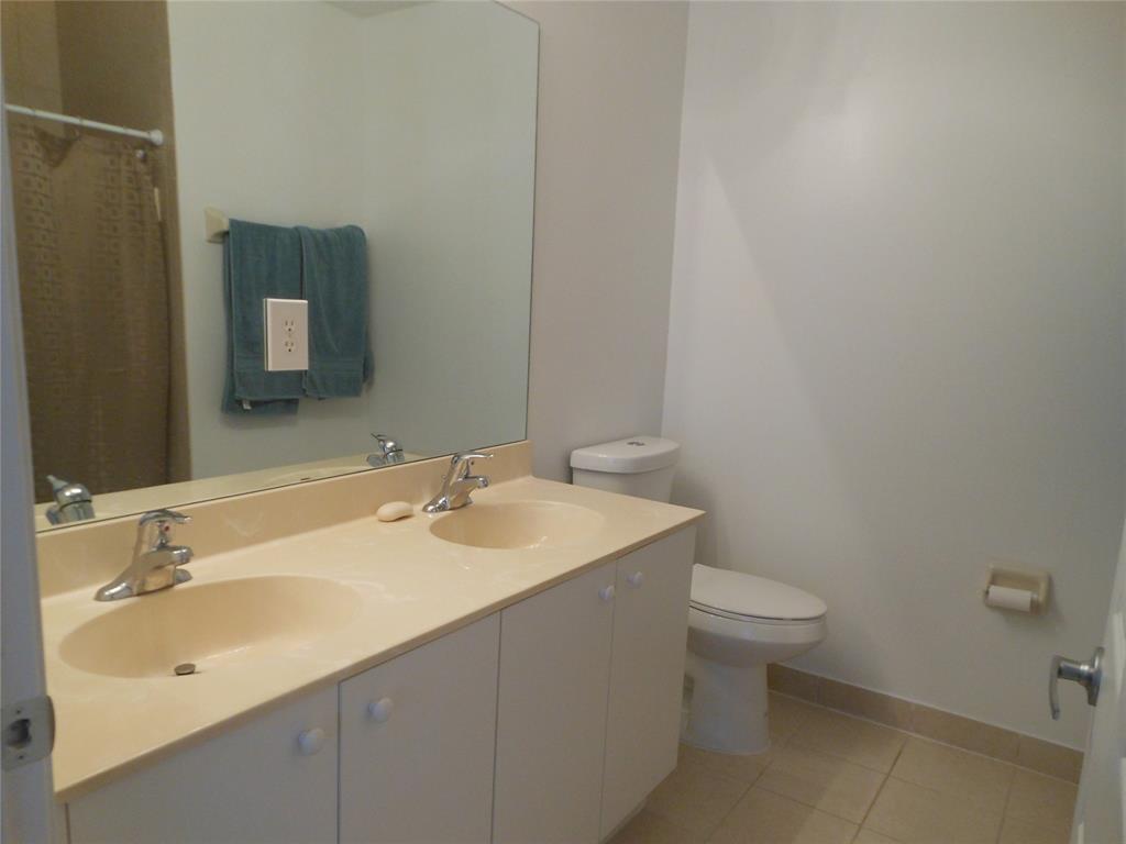 6366 Landings Way, Unit 6366 Tamarac, FL 33321 - Photo 10 of 19 a bathroom with a sink toilet and mirror