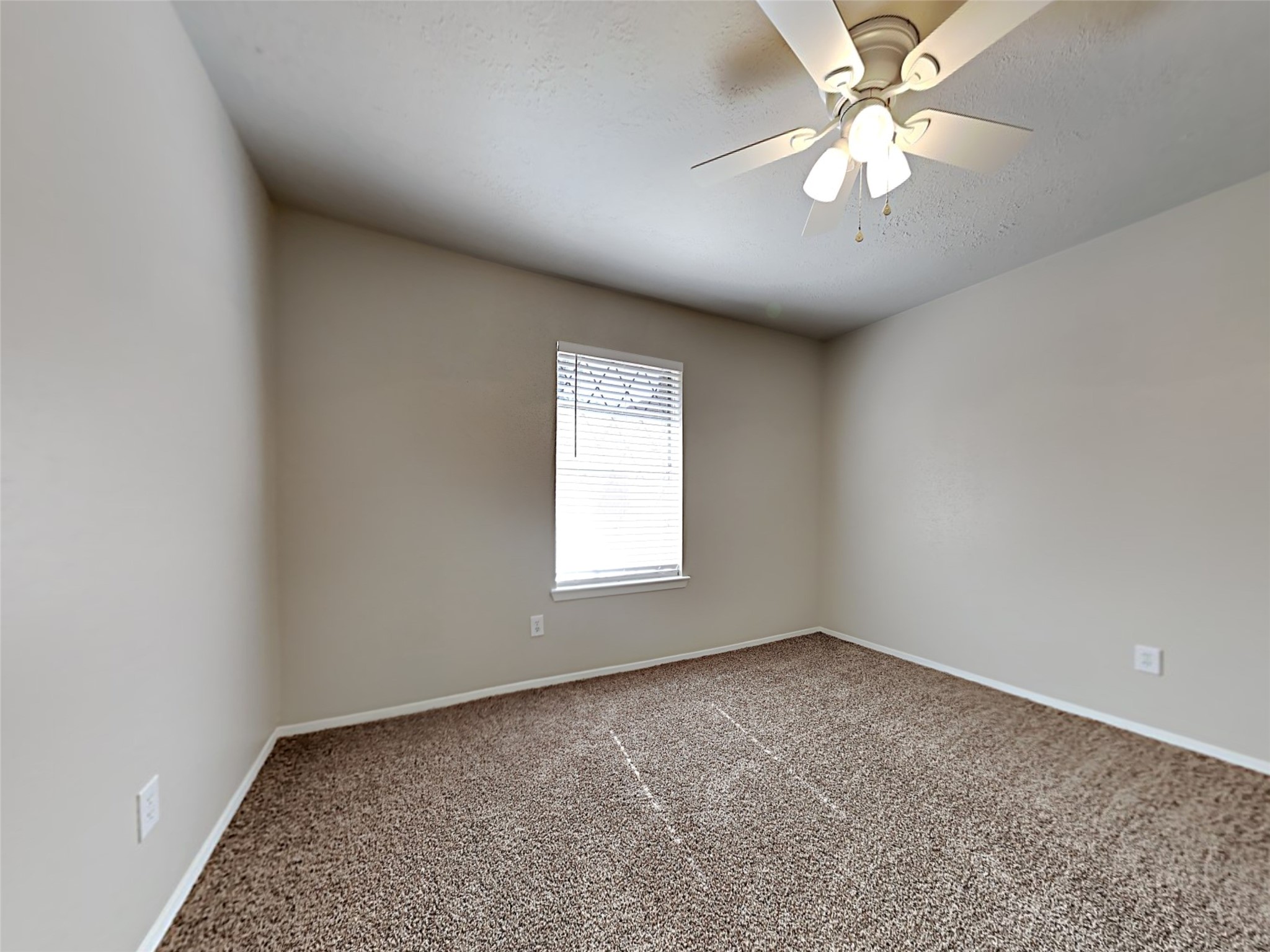14919 Wainsfield Lane Channelview, TX 77530 - Photo 7 of 17 an empty room with a window and a fan