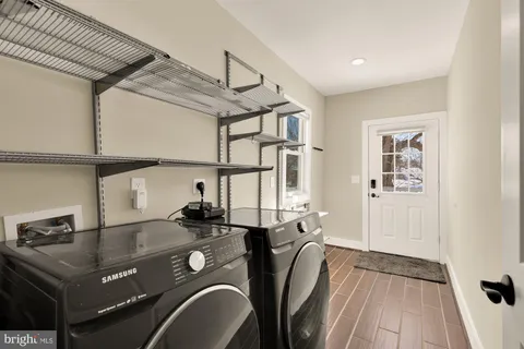 a dining room with furniture and a floor to ceiling window