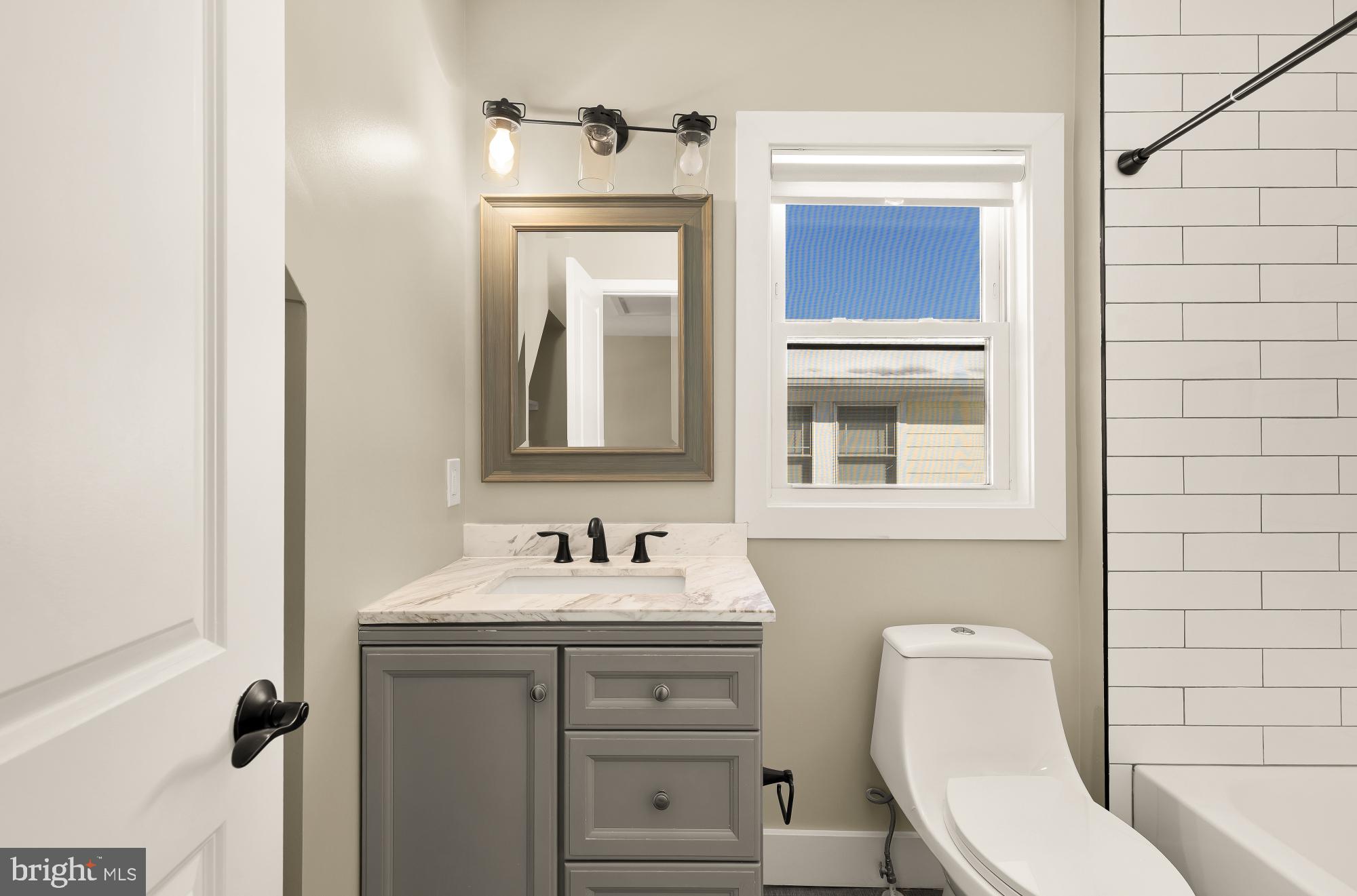 6519 Piney Branch Road Northwest Washington, DC 20012 - Photo 32 of 47 a bathroom with a toilet sink and mirror