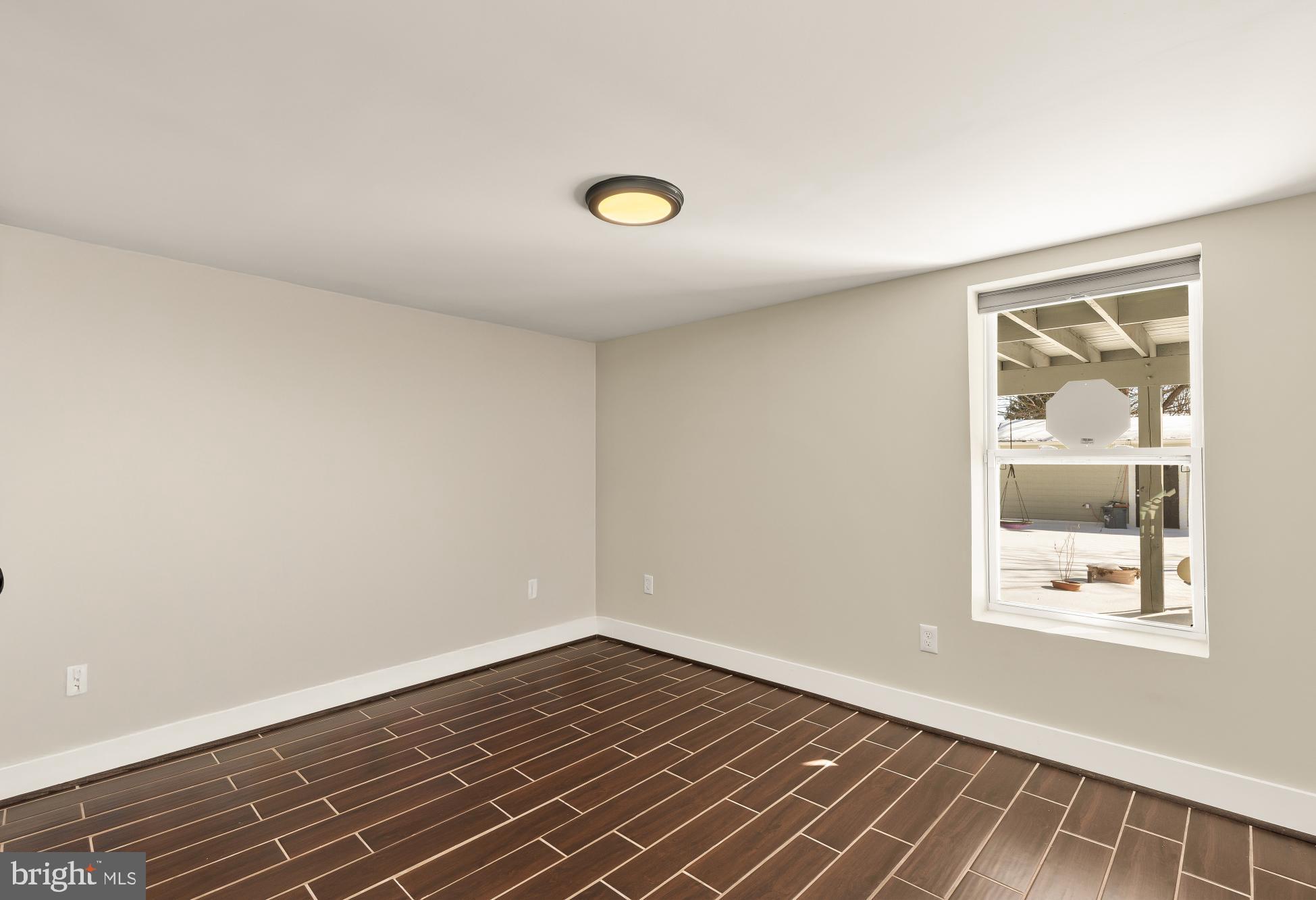 6519 Piney Branch Road Northwest Washington, DC 20012 - Photo 42 of 47 an empty room with wooden floor and windows