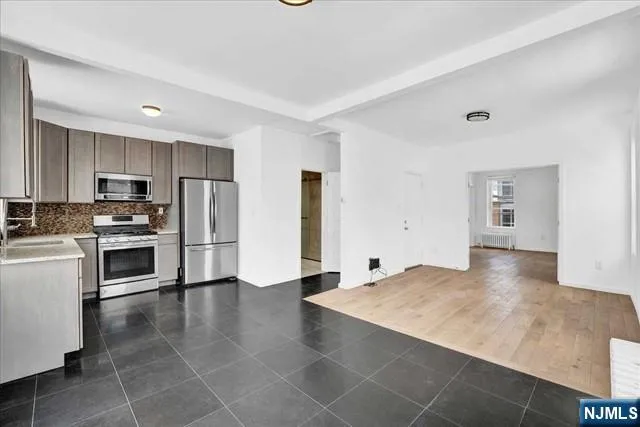 a view of a kitchen with a sink stove cabinets
